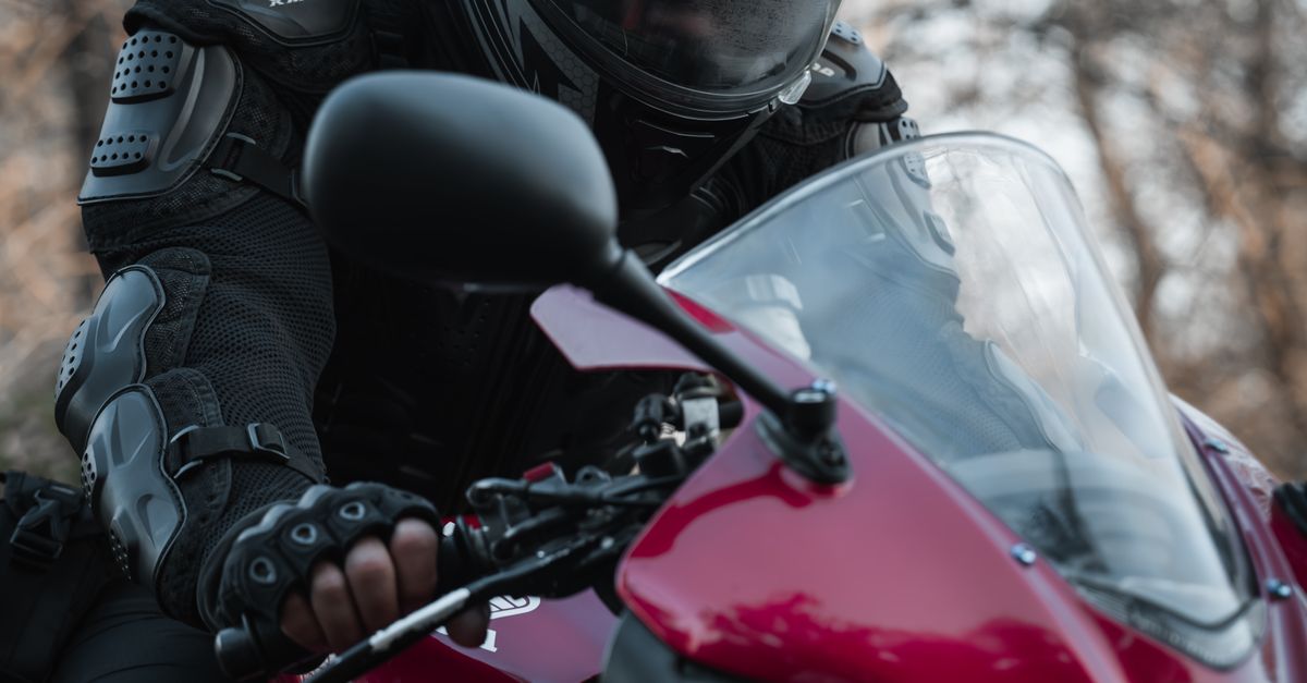 Motorcyclist in Full Gear Riding Red Sport Bike · Free Stock Photo