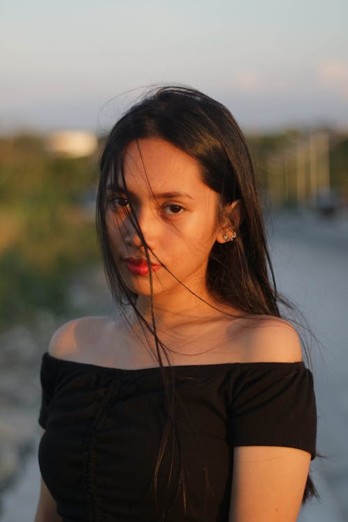 Woman Wearing Black Off-Shoulder Top