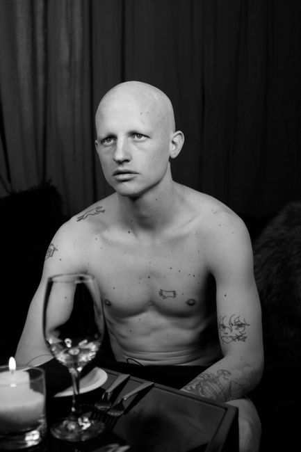 Monochrome portrait of a bald, tattooed man in Buenos Aires, Argentina.