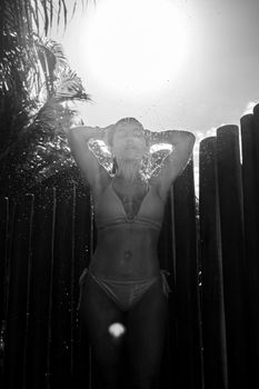 Captivating black and white portrait of a woman under sunlight in Porto Seguro, Brazil.