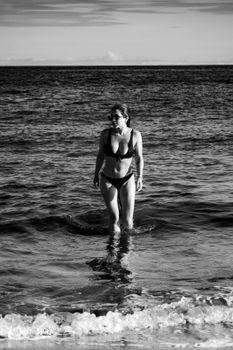 Artistic black and white photo of a woman in the ocean at Porto Seguro, Brazil.