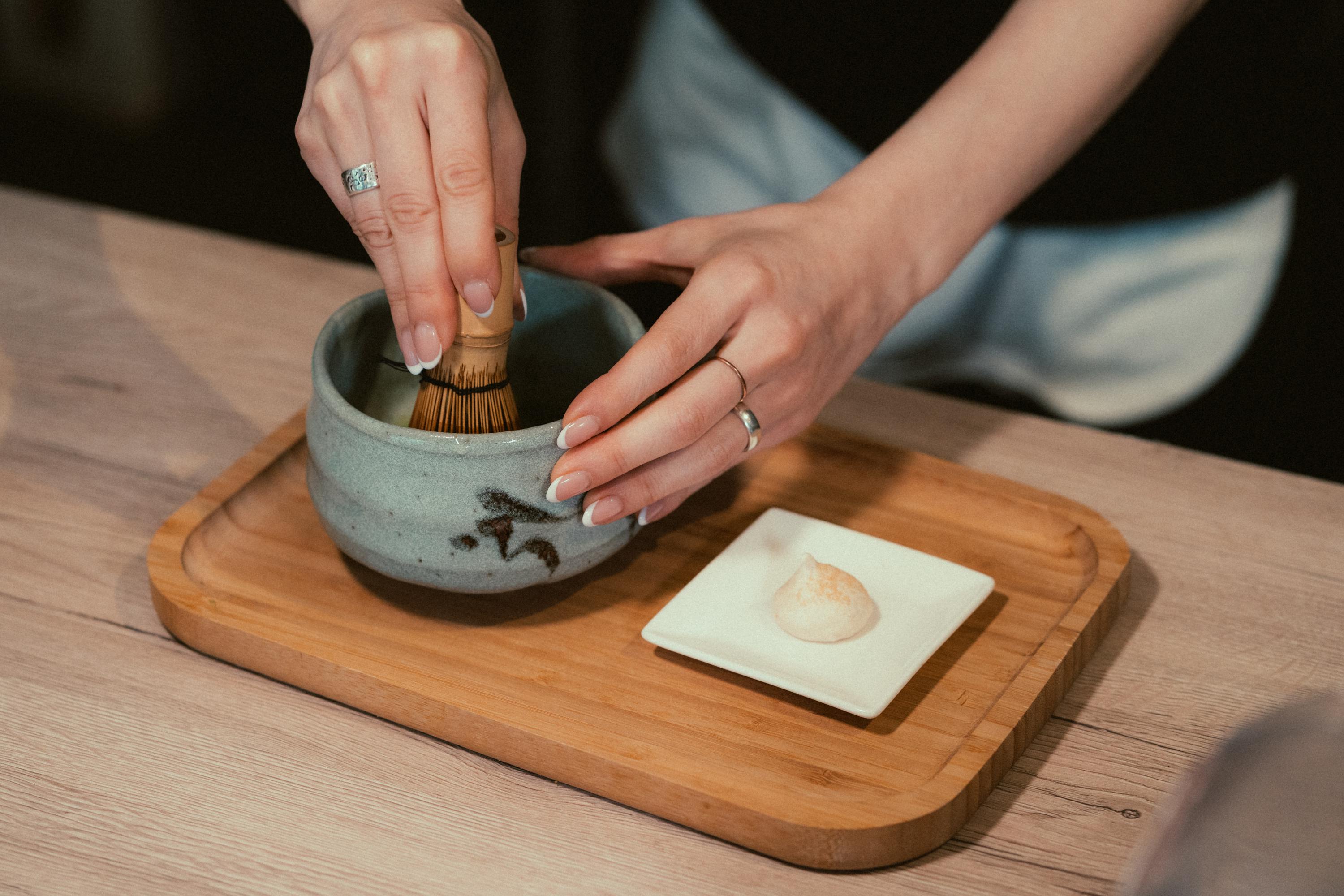 A tea master gracefully whisking matcha into a froth - authentic Japanese tea ceremony