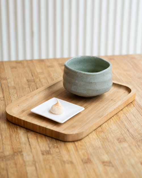 Free Elegant minimalist ceramic bowl on a wooden tray perfect for dining. Stock Photo