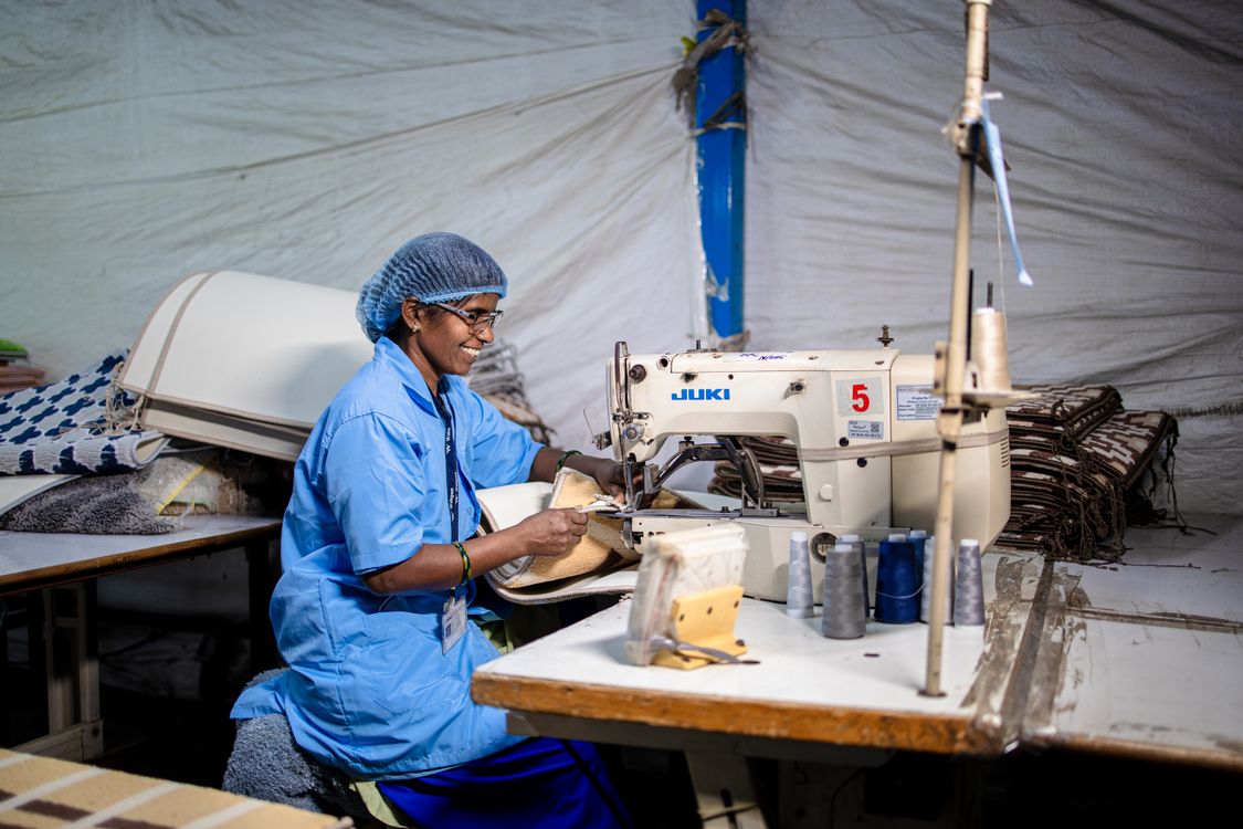 Smiling Textile Worker Sewing in Factory · Free Stock Photo