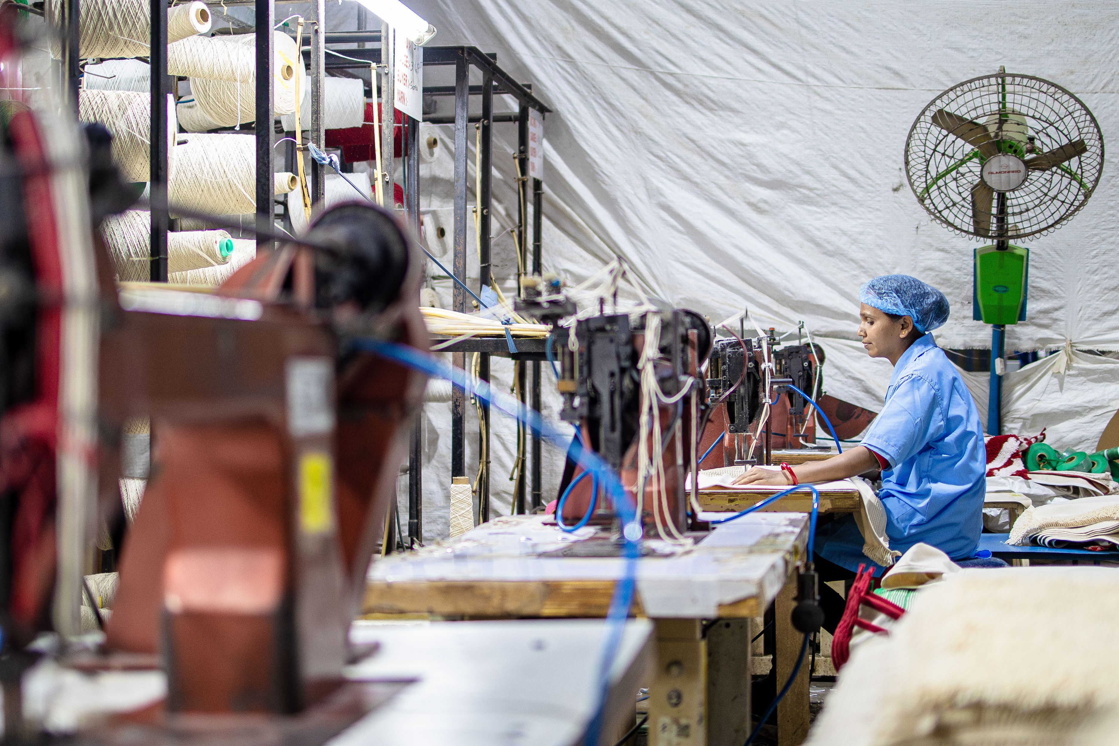 Textile Factory Worker Operating Sewing Machines · Free Stock Photo