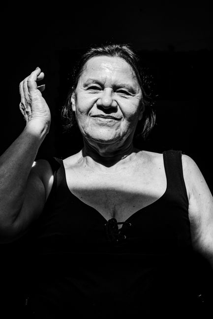Captivating black and white portrait capturing a woman's genuine smile in natural light.
