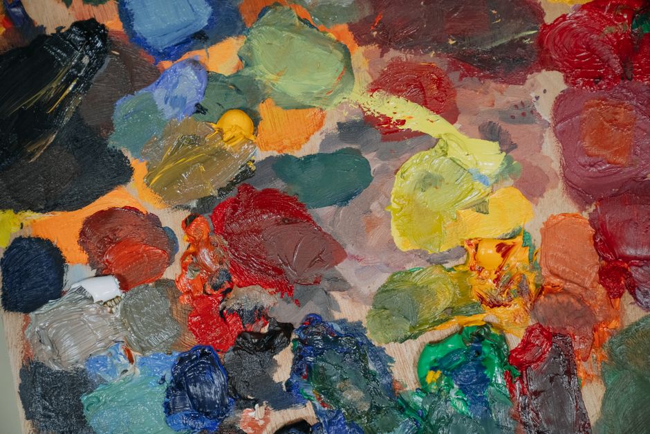 A colorful assortment of oil paints smeared on a canvas, showcasing various vibrant hues.