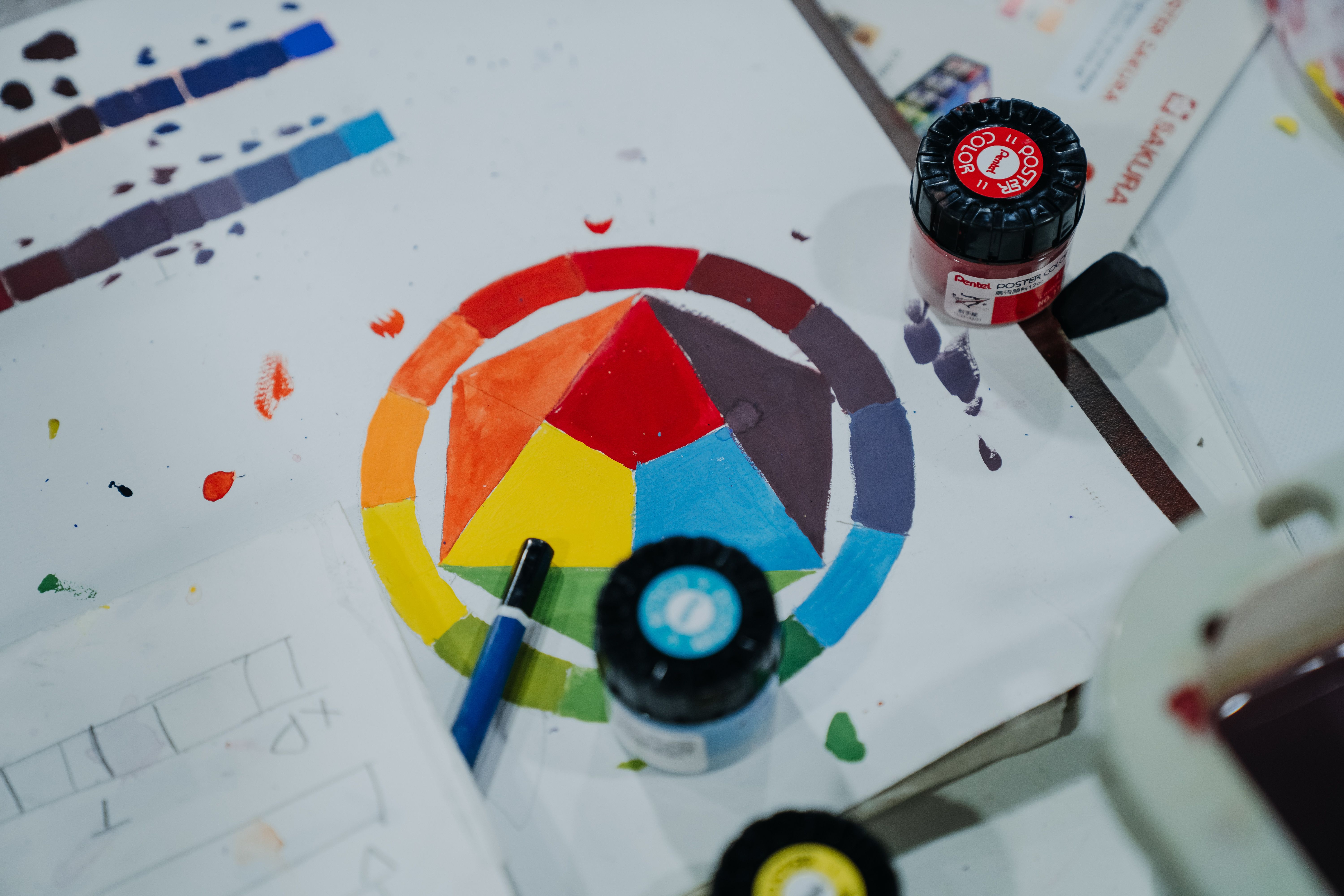 Vibrant Color Wheel with Paints on Table · Free Stock Photo