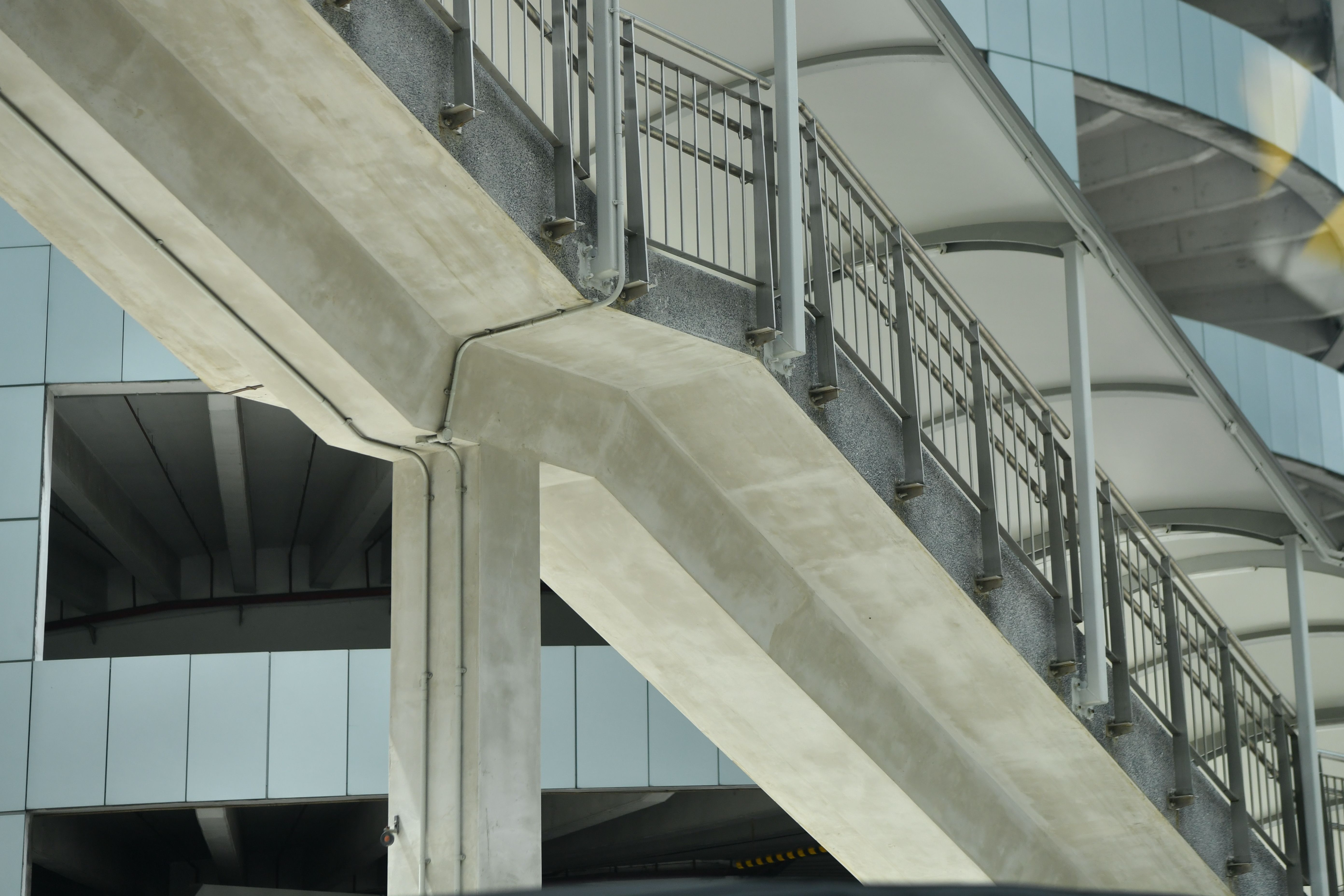 Close-up view of concrete and metal urban architecture showcasing geometric design elements.