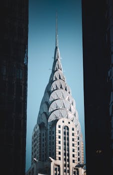 Iconic Chrysler Building framed by shadows of surrounding skyscrapers in New York City