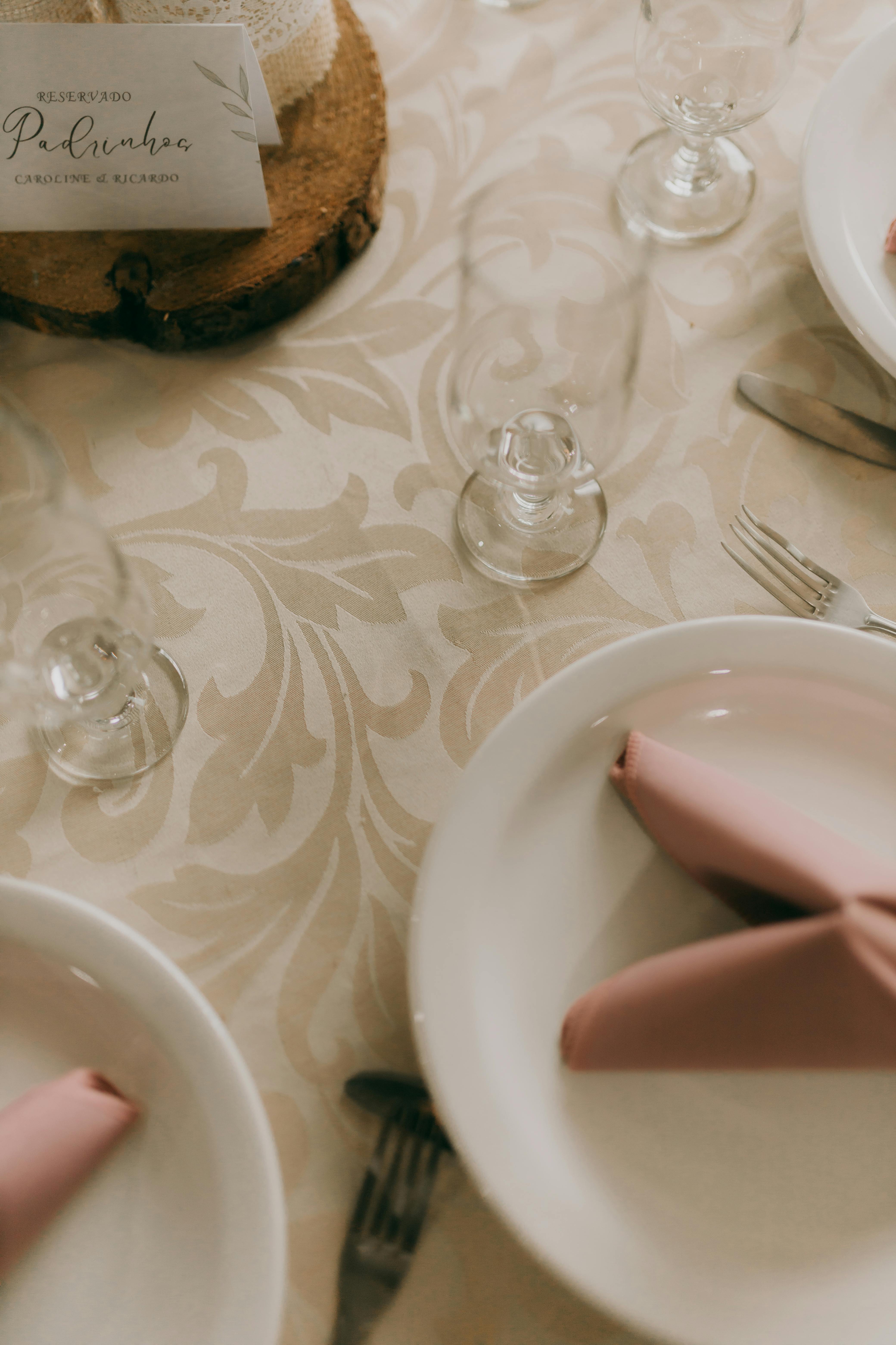 Beautifully arranged table setting with elegant dinnerware and folded pink napkins.