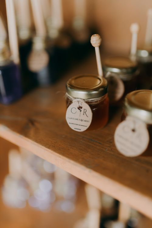 Free Close-up of artisanal honey jars with dipper sticks on a rustic wooden shelf. Stock Photo