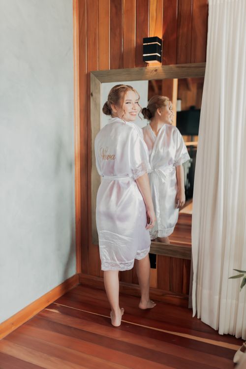 Indoor Robe Woman in Satin Robe Smiling at Mirror Indoors · Free Stock Photo