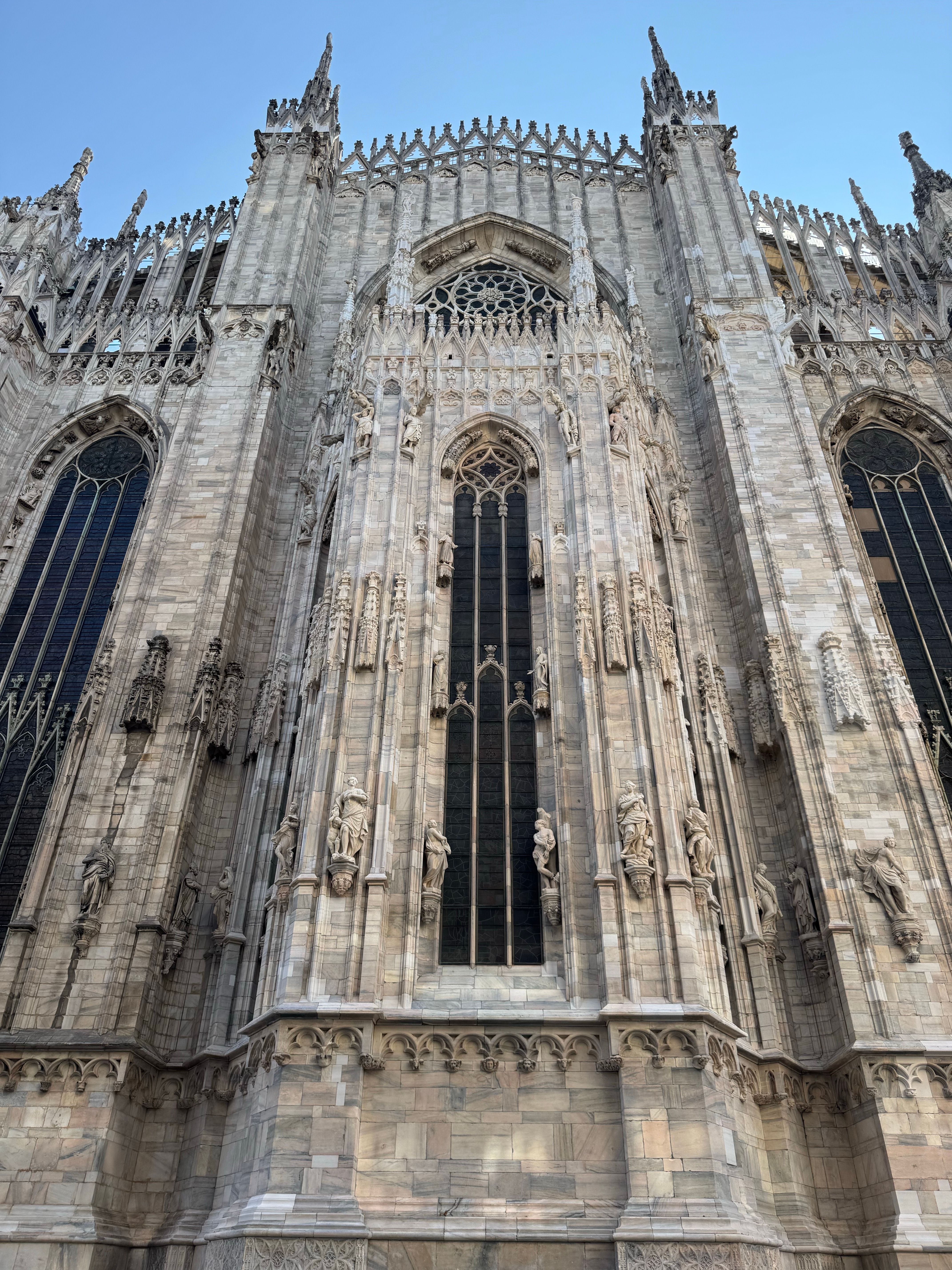 Detailed view of Milan Cathedral's Gothic facade showcasing intricate architectural designs.