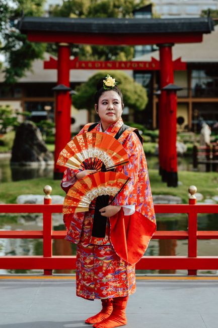 Elegant portrayal of a woman in traditional kimono with a fan at the Buenos Aires Japanese Garden.