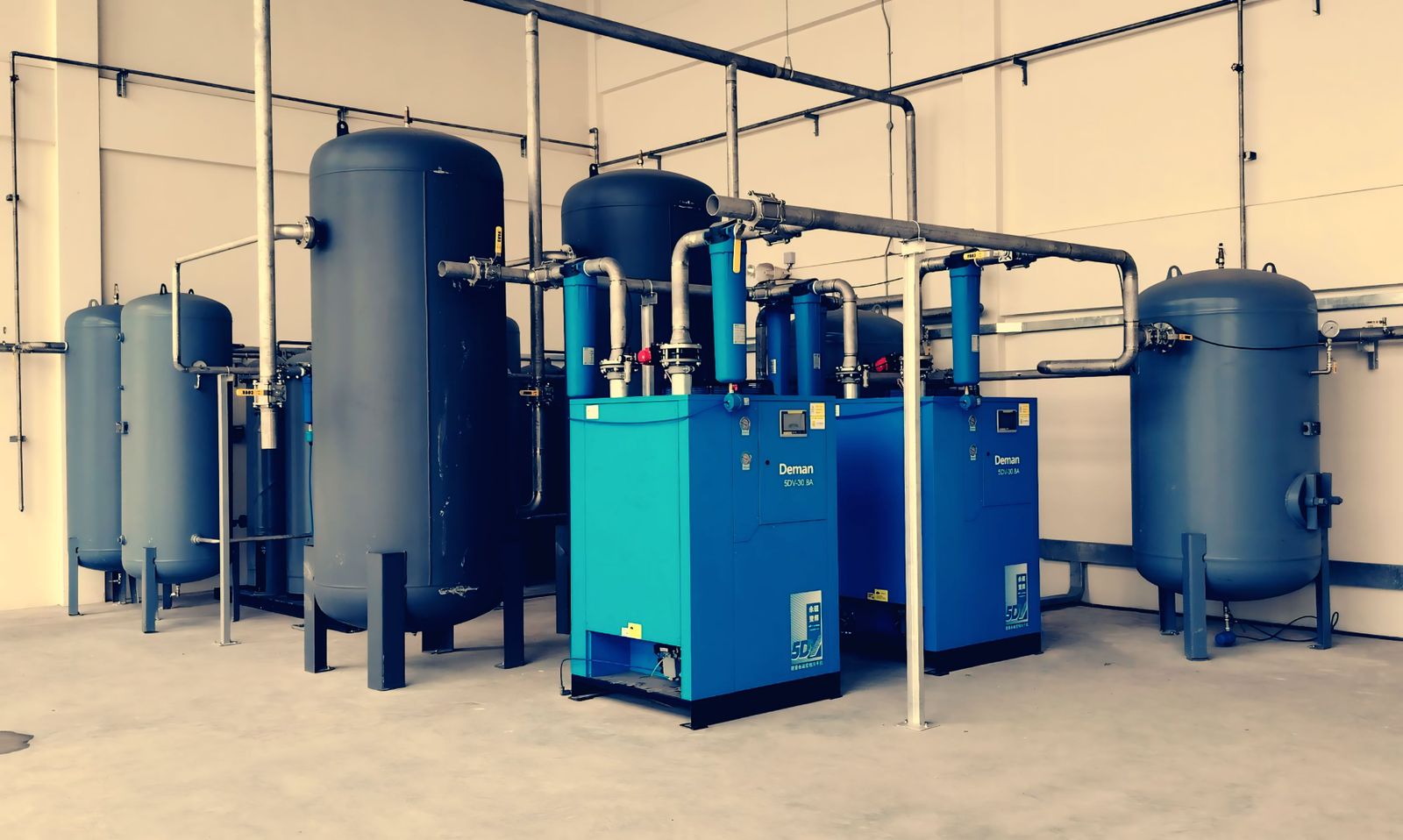 Air compressor with twin tanks set up in a clean home garage workshop ready for DIY projects