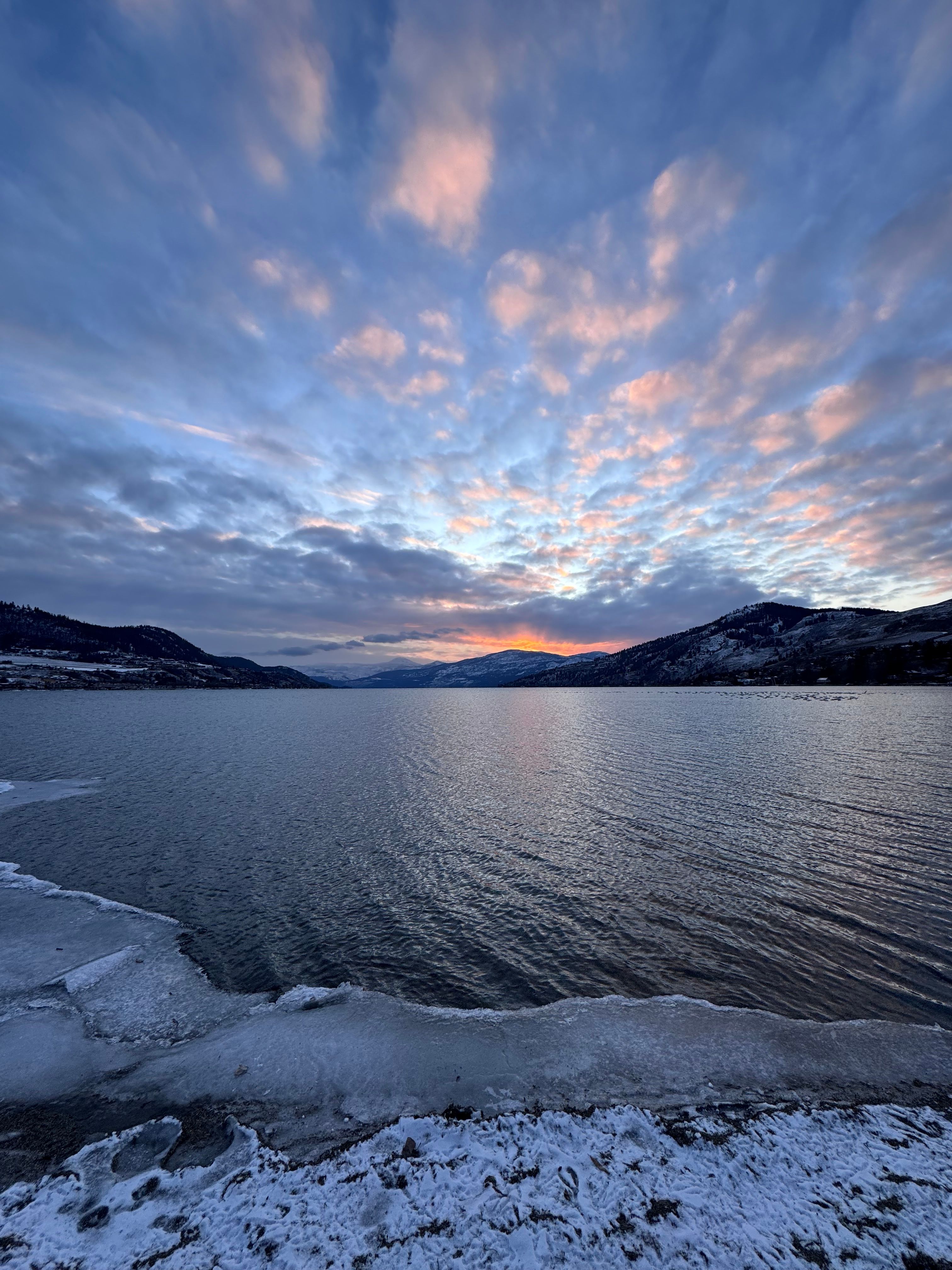 Serene Winter Sunset Over Frozen Lake · Free Stock Photo