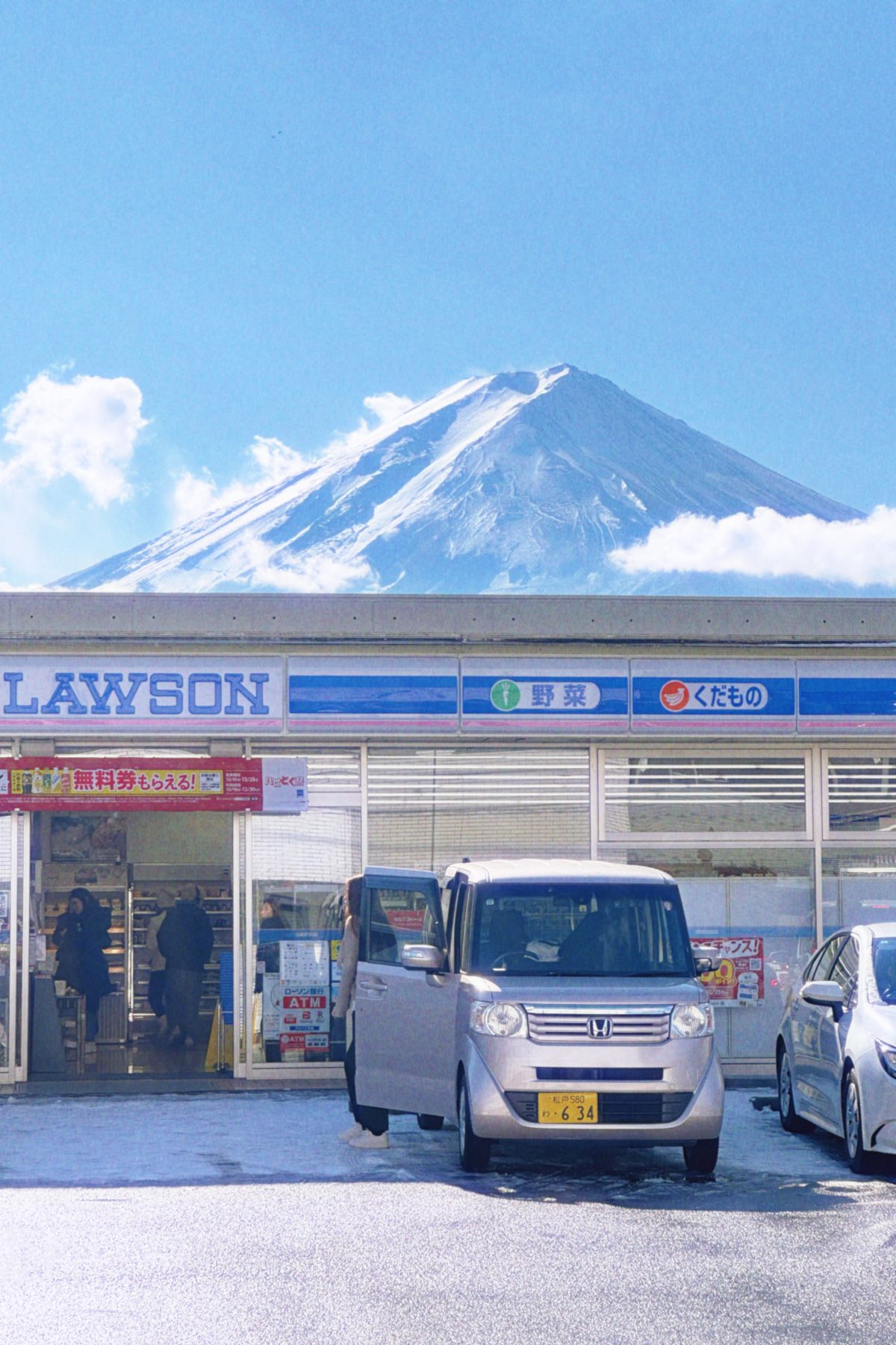Japanese Shinkansen bullet train speeding through countryside with Mount Fuji in background