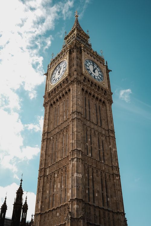 Free Stunning upward view of Big Ben's Elizabeth Tower against a clear sky in London. Stock Photo
