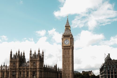 Free A classic view of Big Ben and the Houses of Parliament under a cloudy sky in London. Stock Photo