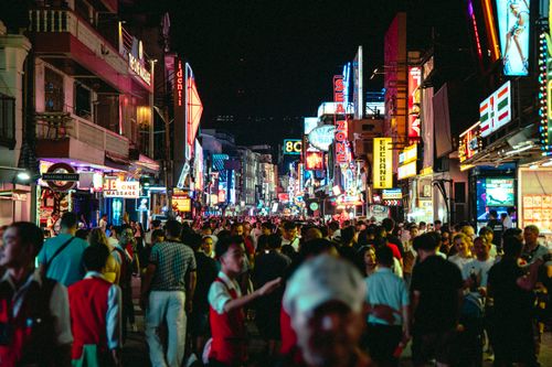 Free Bustling crowd and neon signs light up Walking Street, a vibrant nightlife hub in Thailand. Stock Photo
