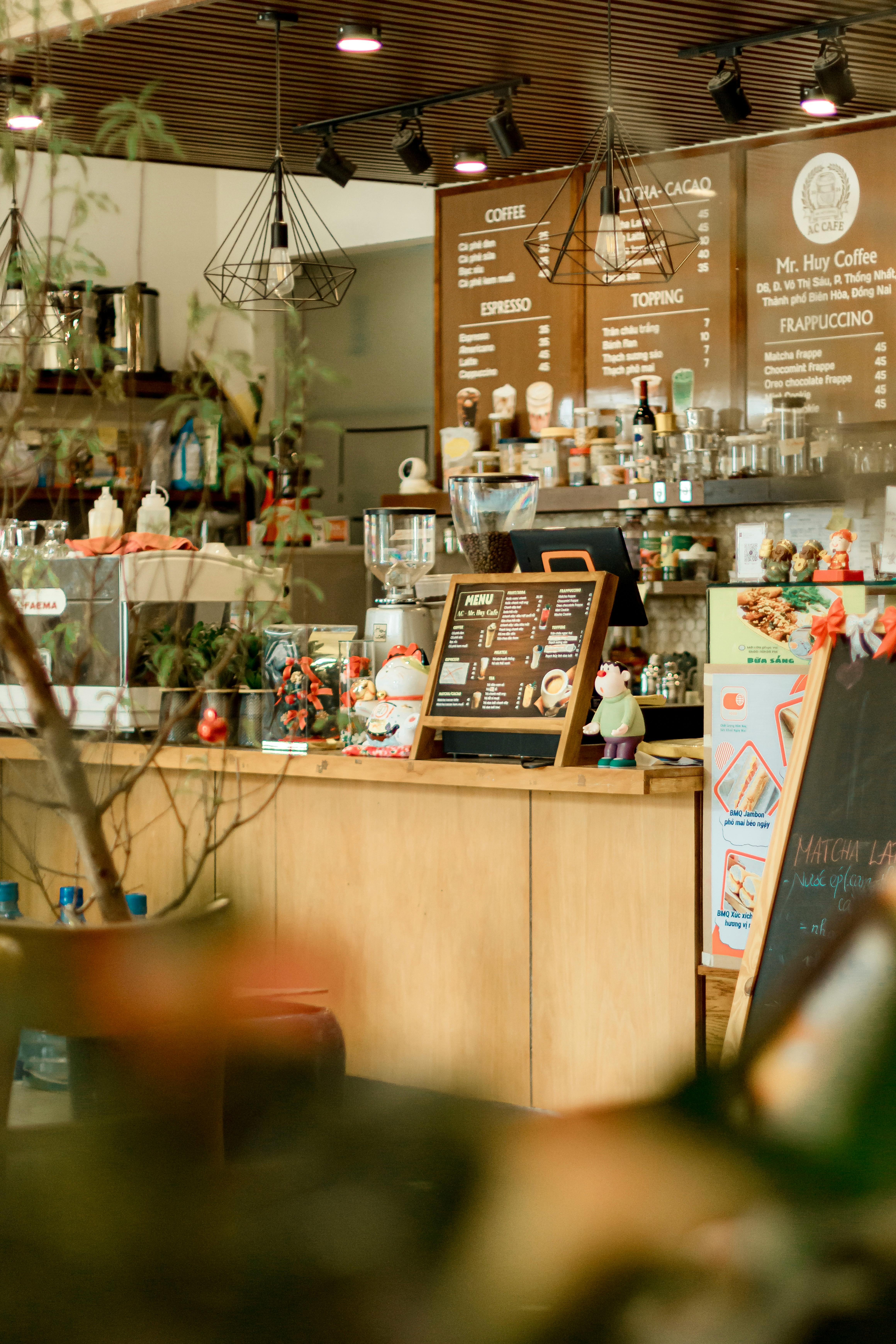 Warm coffee shop interior with menu board and decor items.