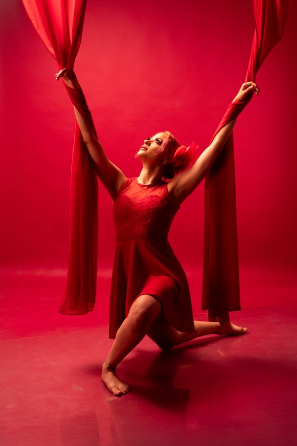 Dancer moving under red light — photo by Israyosoy S. on Pexels
