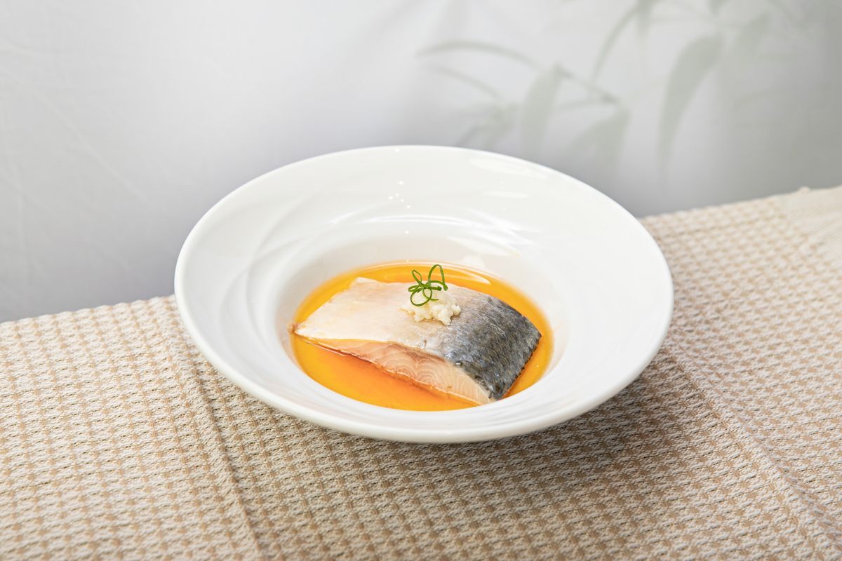 Cooked salmon fillet plated with citrus sauce, a natural dietary source of omega-3