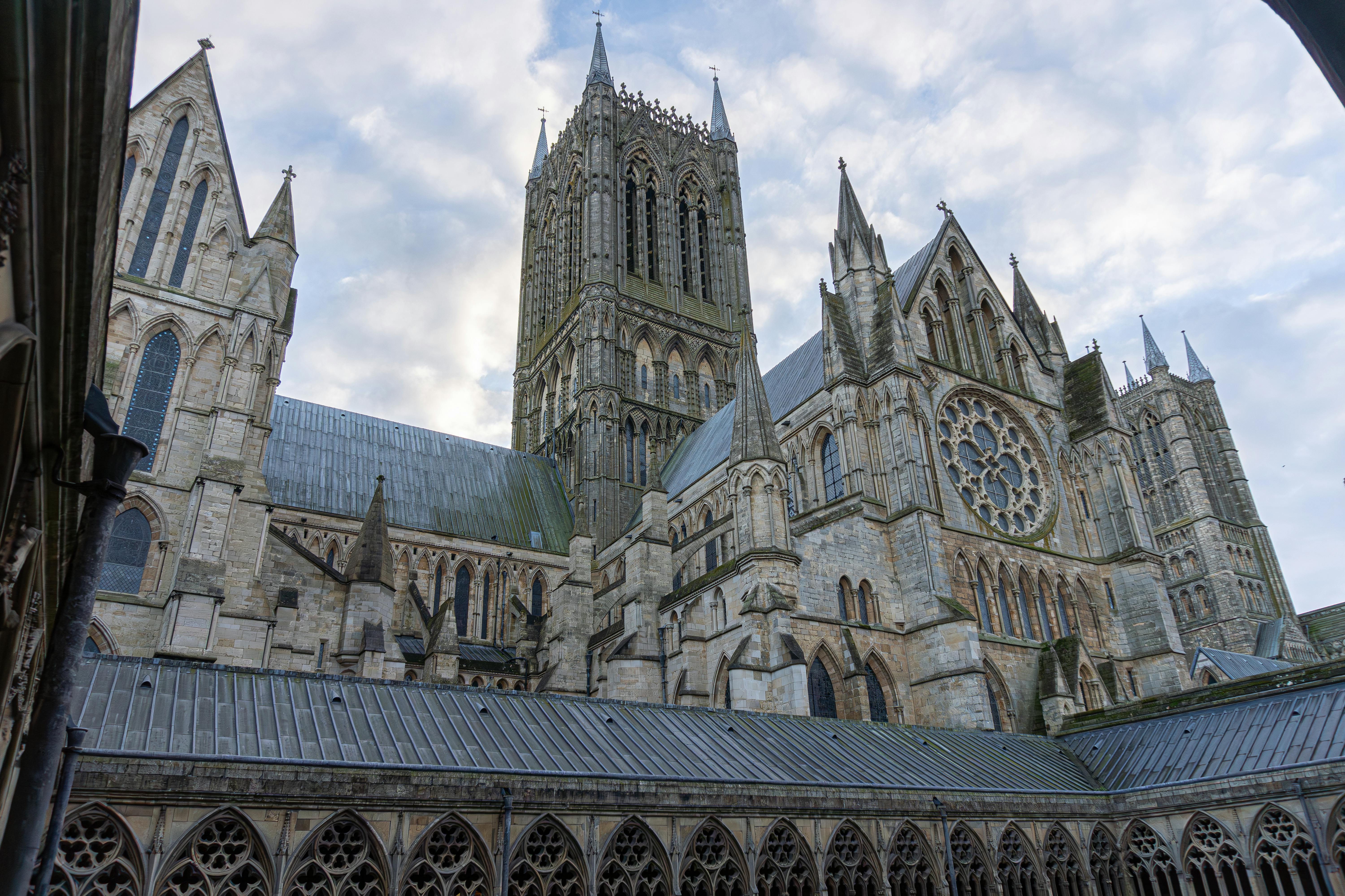 Lincoln Cathedral's stunning Gothic spires and intricate stonework against a serene sky.