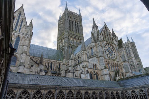 Lincoln Cathedral's stunning Gothic spires and intricate stonework against a serene sky.
