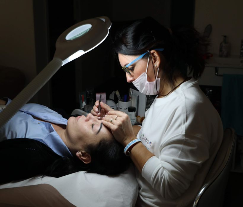 Brow work being carried out under focused light
