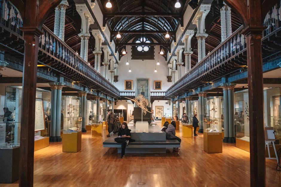 Interior view of a historic Scottish museum with visitors exploring exhibitions.