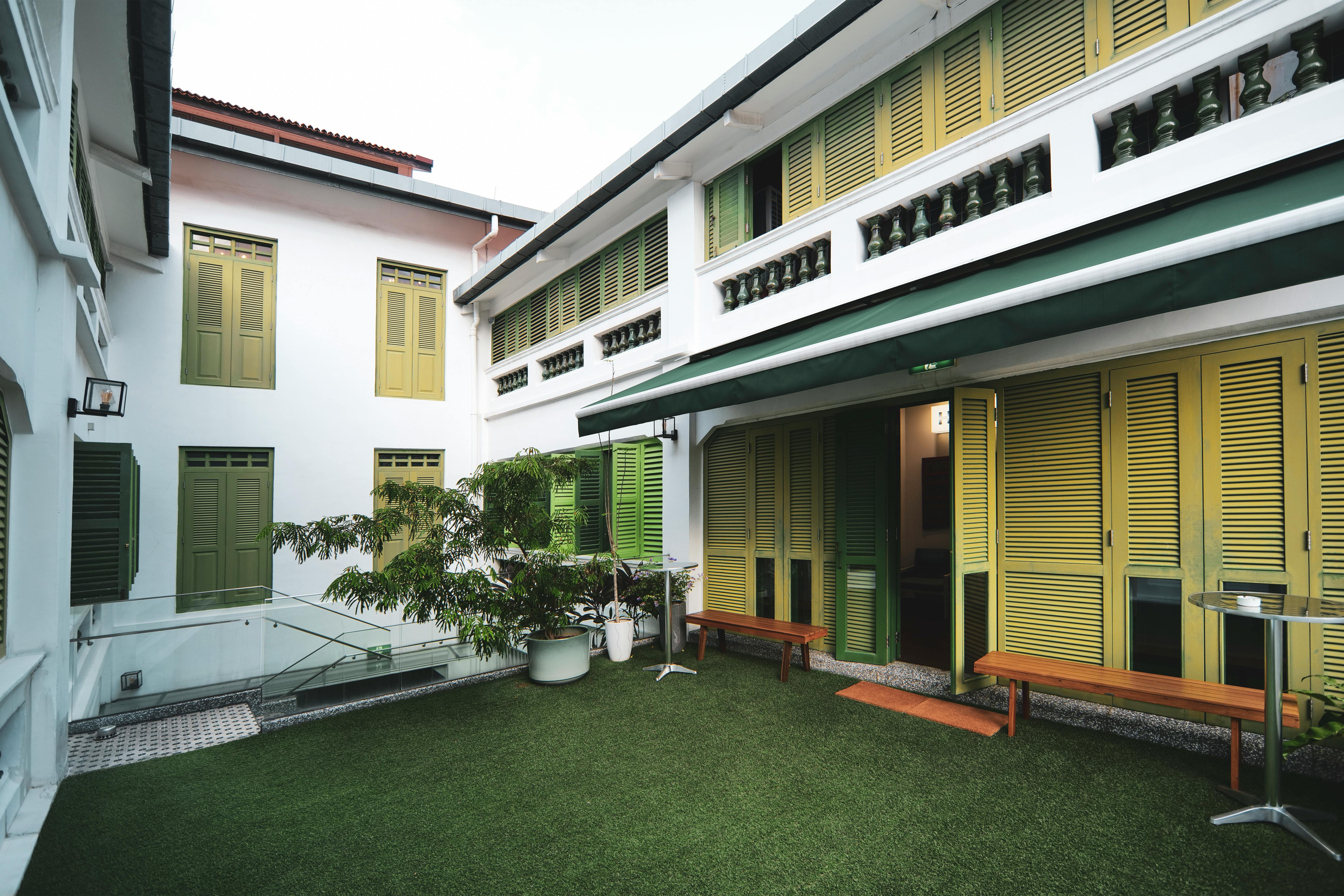 An image of a backyard with an artificial turf   