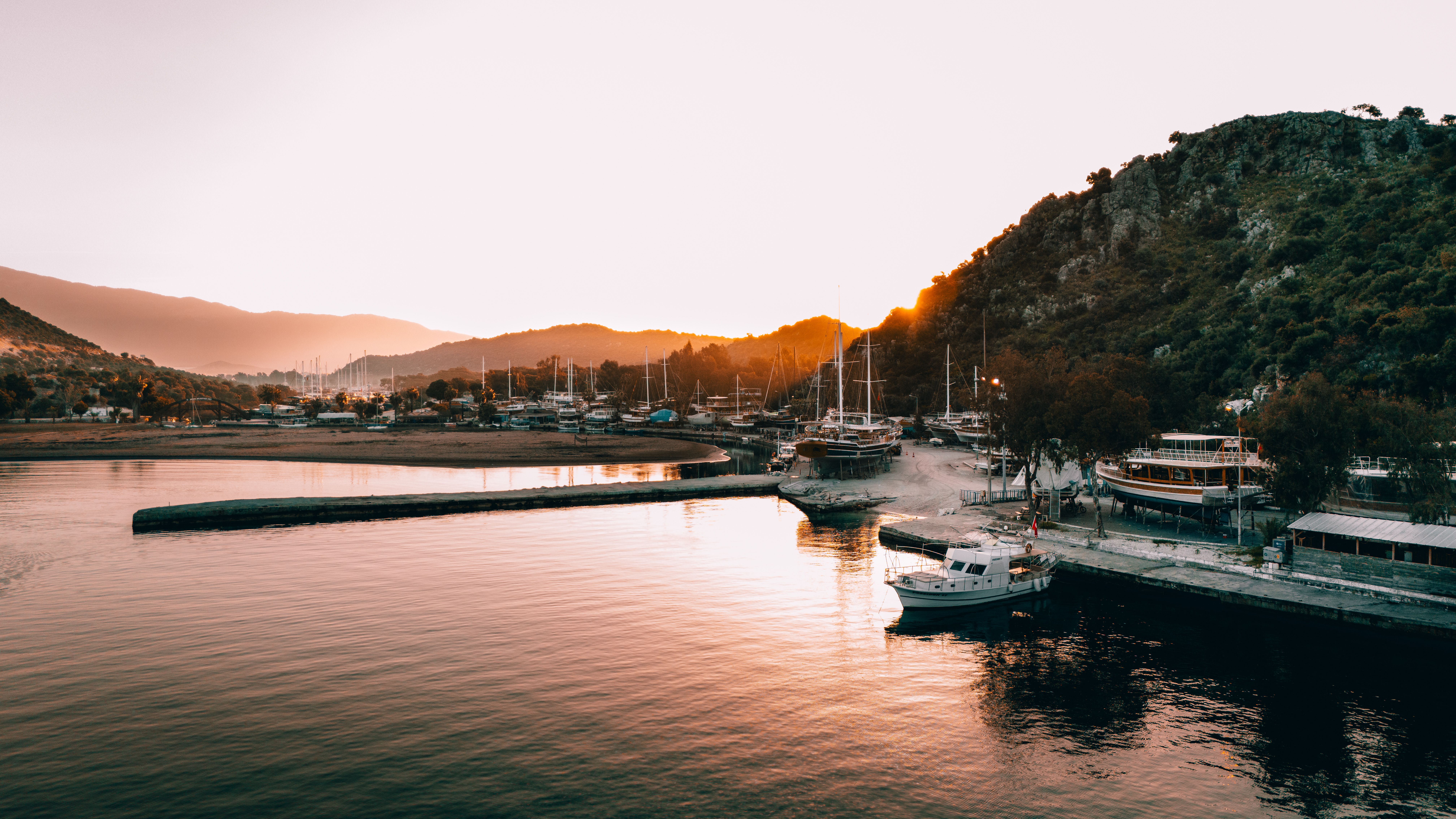Serene Harbor at Sunset with Docked Boats · Free Stock Photo