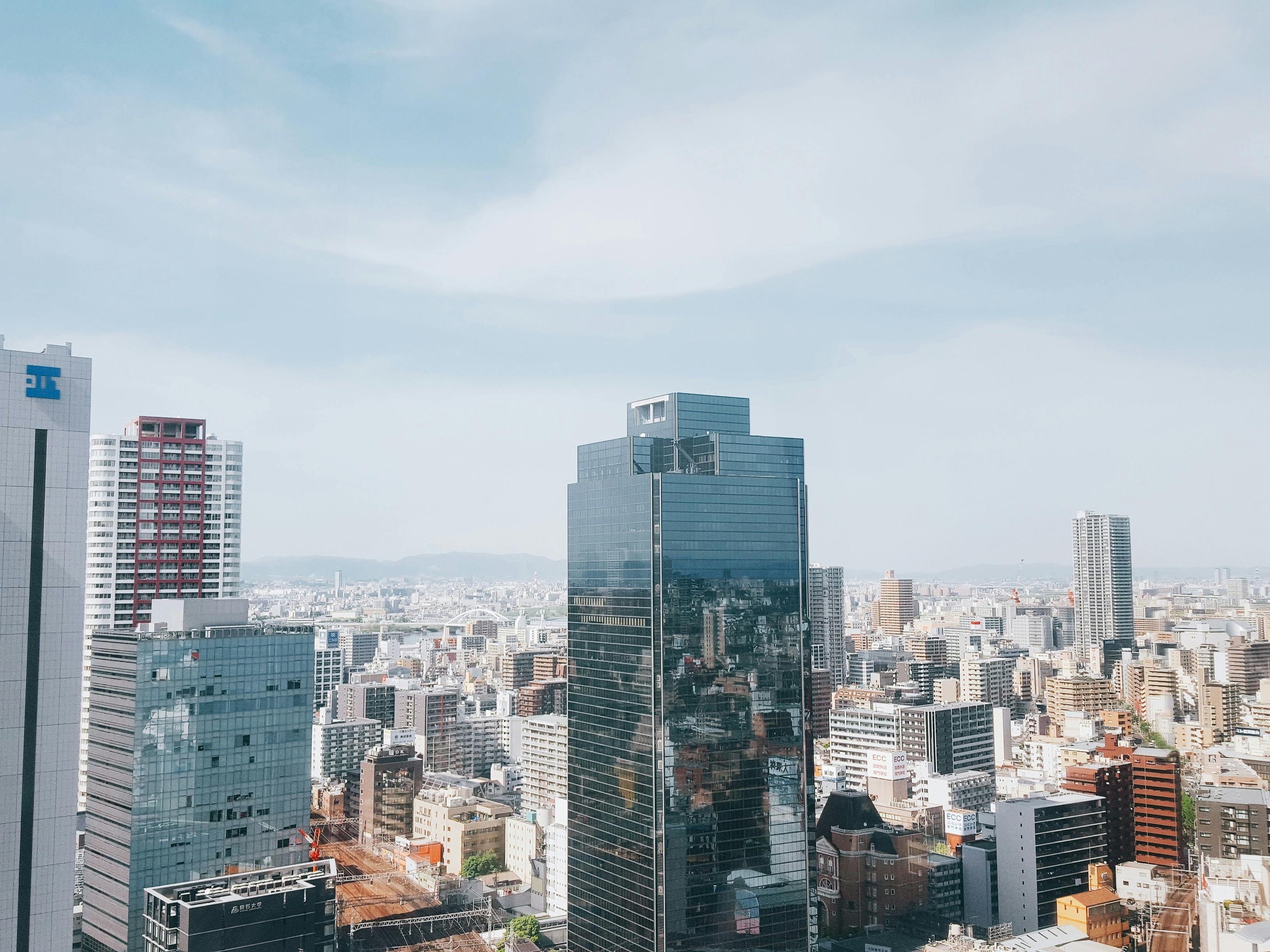A clear view of a city's skyline featuring modern skyscrapers and urban architecture under a blue sky.