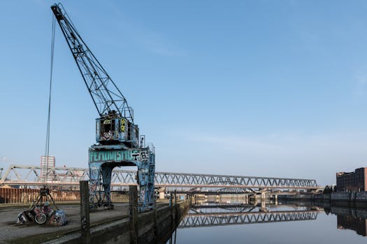 Industrial crane near a bridge over water in Hamburg, Germany.