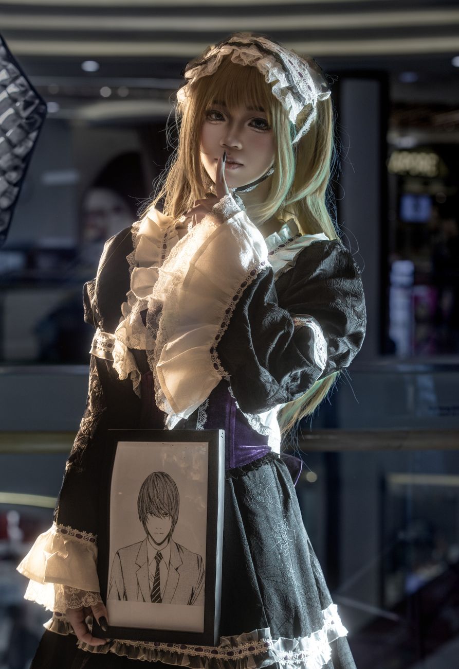 A captivating indoor portrait of a person in elaborate anime cosplay holding a character sketch.. captivating, indoor, portra