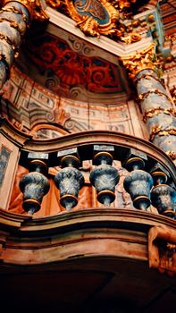 Close-up of ornate Baroque architectural elements with vibrant colors and intricate carvings.