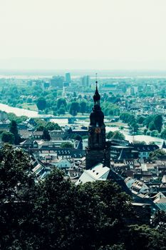 High-angle view capturing the charming skyline of a historic European city with a prominent church tower.