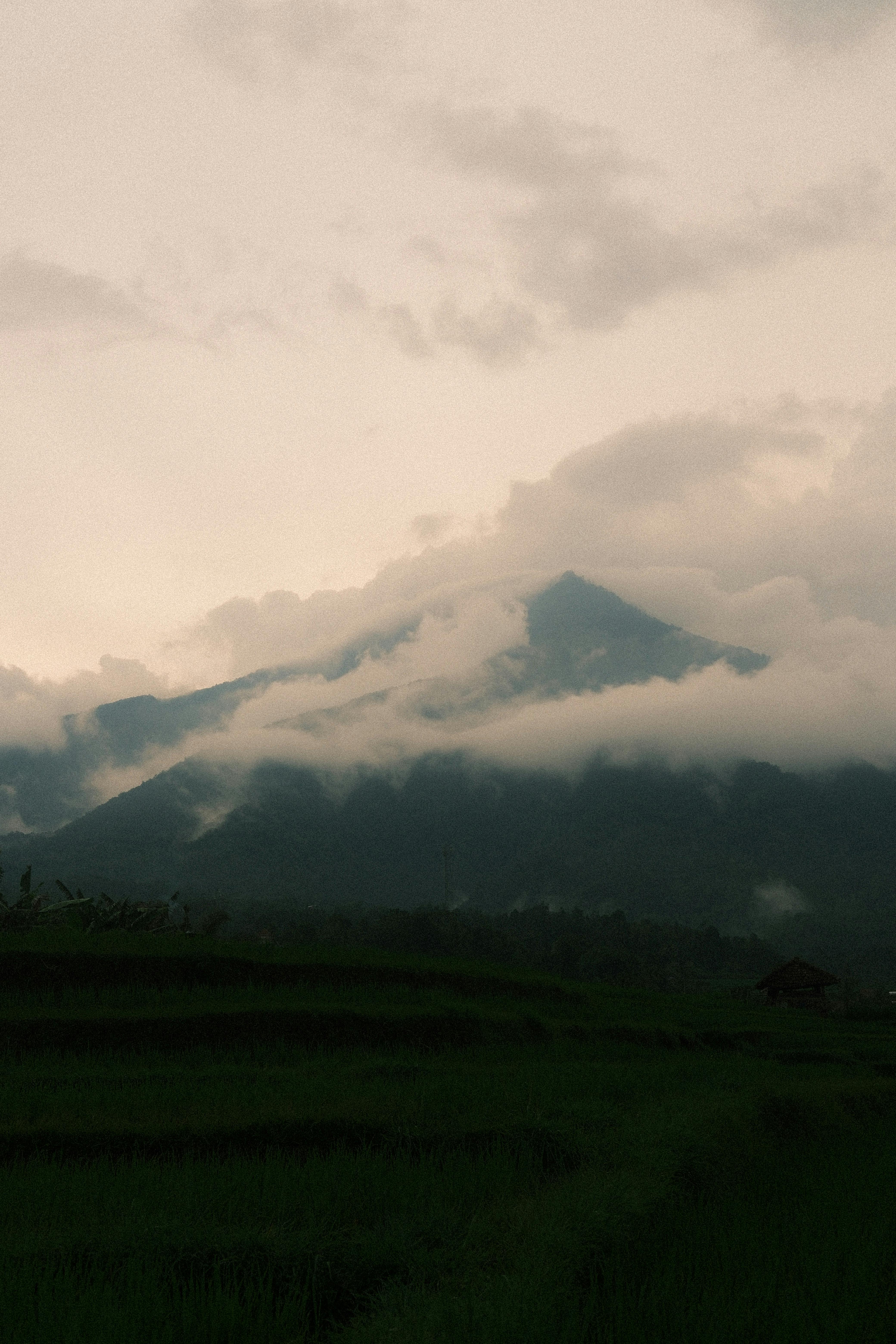 Serene image of a mountain shrouded in clouds, capturing nature’s tranquil beauty.