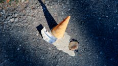 Fallen Ice Cream Cone on Asphalt Surface