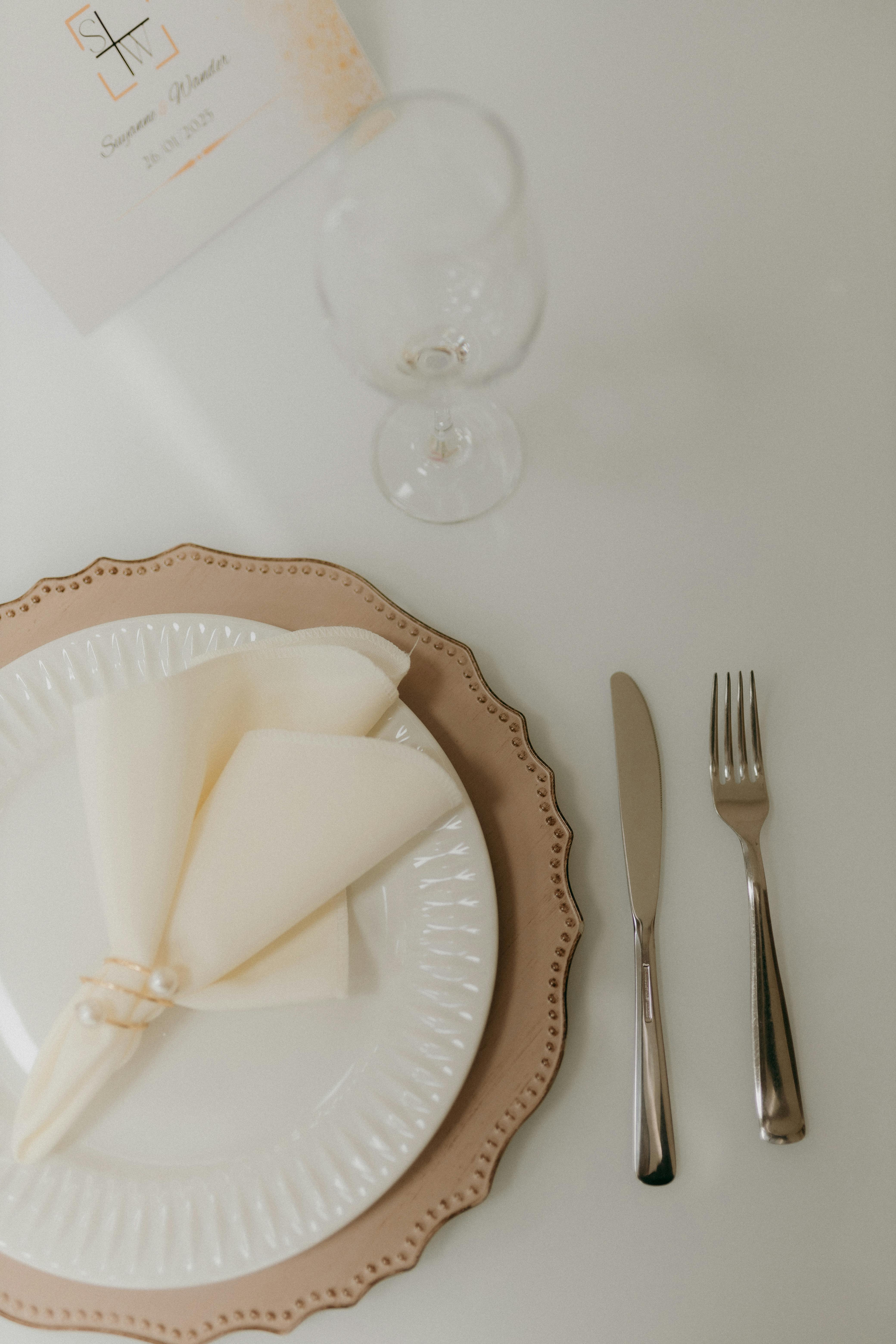 Chic table setting featuring a plate, napkin, and cutlery, perfect for weddings or events.