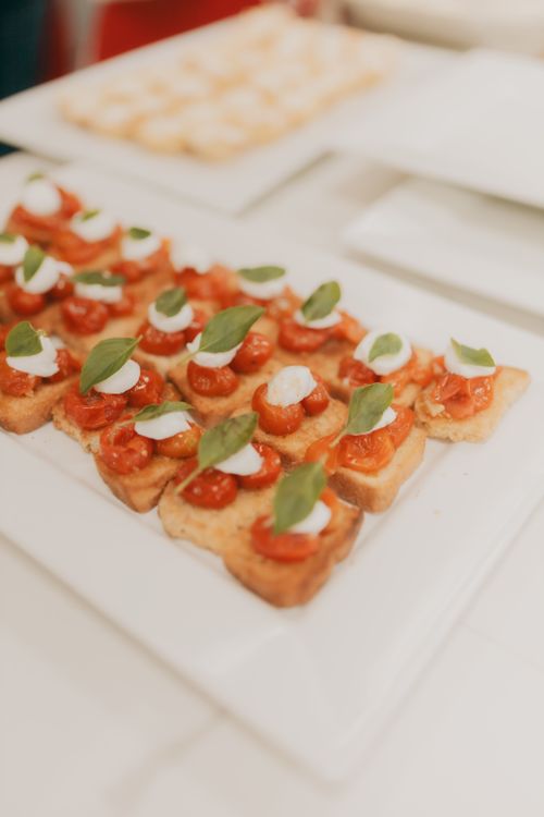 Free Fresh bruschetta with tomatoes, mozzarella, and basil leaves elegantly served on a plate. Stock Photo