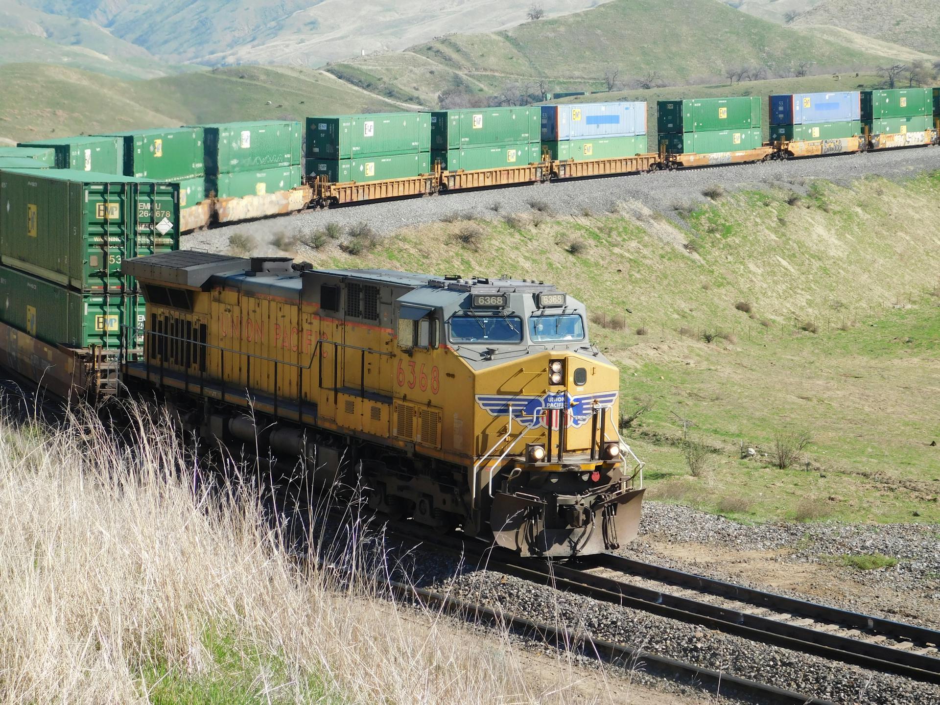 A Union Pacific freight train travels through the scenic hills of California, USA.