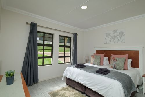 Free Beautifully decorated modern bedroom featuring a large bed, elegant curtains, and natural light. Stock Photo