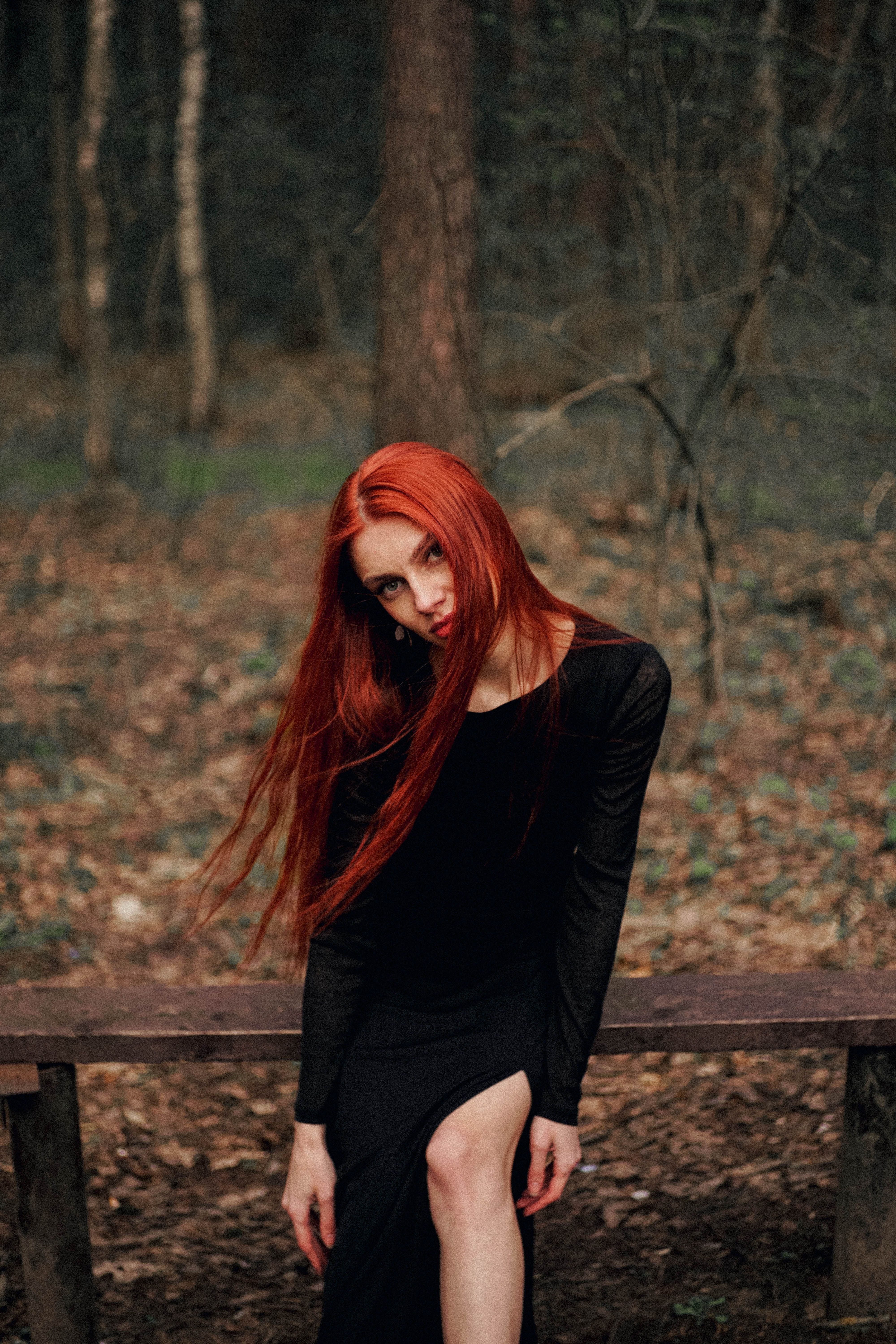 Red-Haired Woman Sitting on Bench in Forest · Free Stock Photo