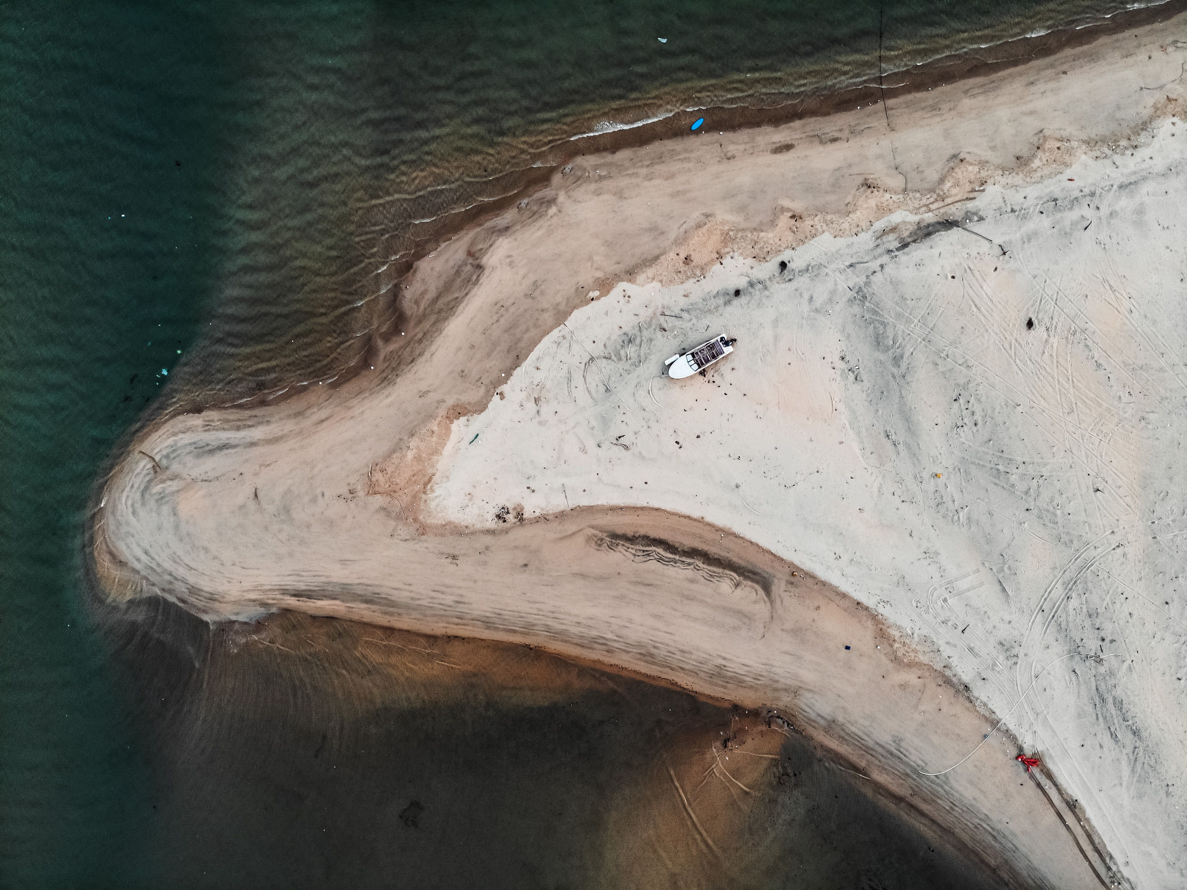 Aerial View of Sandy Shoreline with Boat · Free Stock Photo