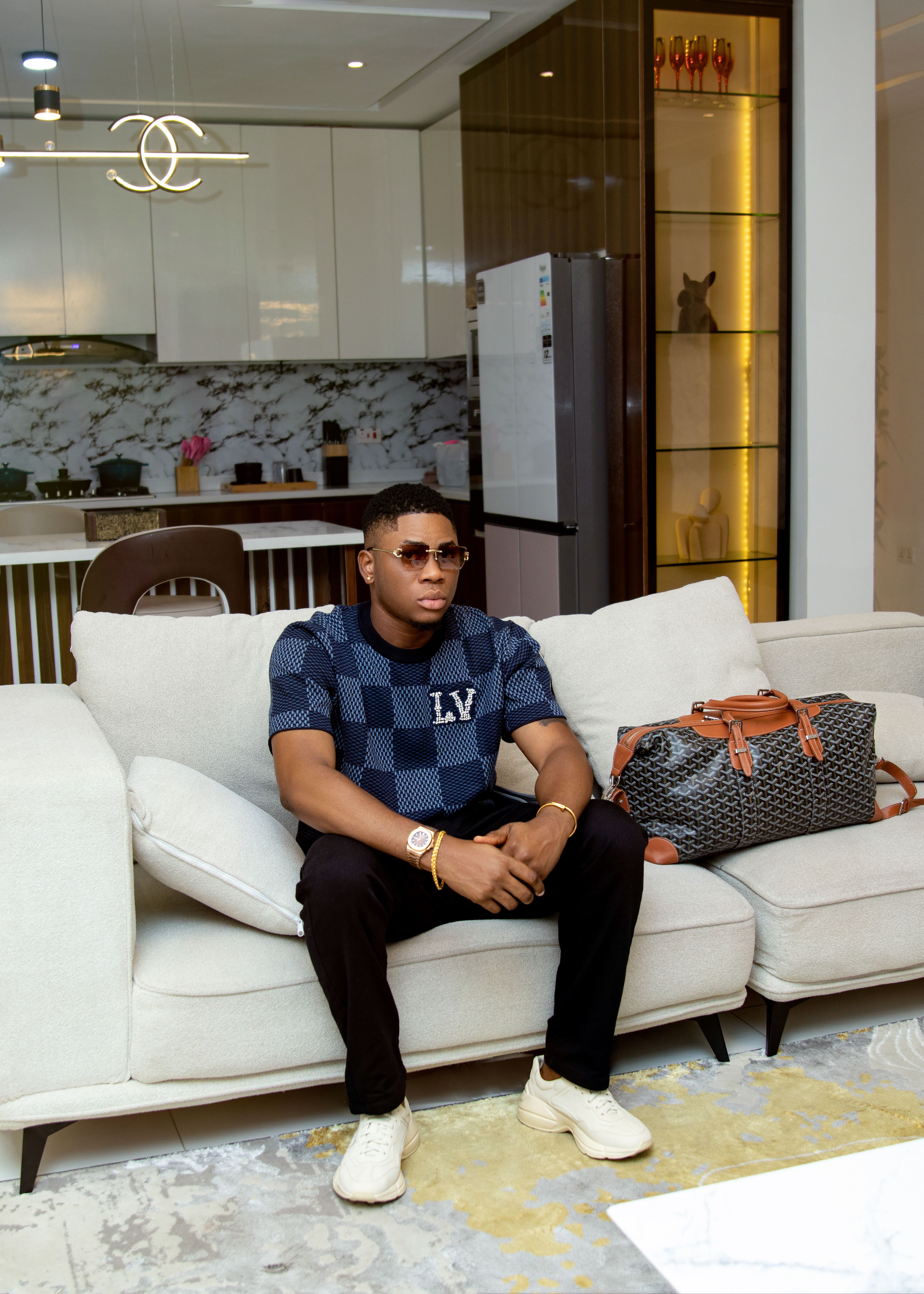 Young man relaxing on sofa in a stylish, modern living room with designer decor.