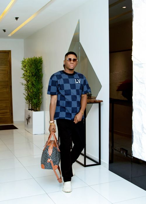 Free Stylish man in designer outfit holding luxury bag indoors. Stock Photo