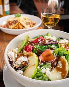 Delicious garden salad featuring fresh fruits, nuts, and a light dressing, perfect for a healthy meal.